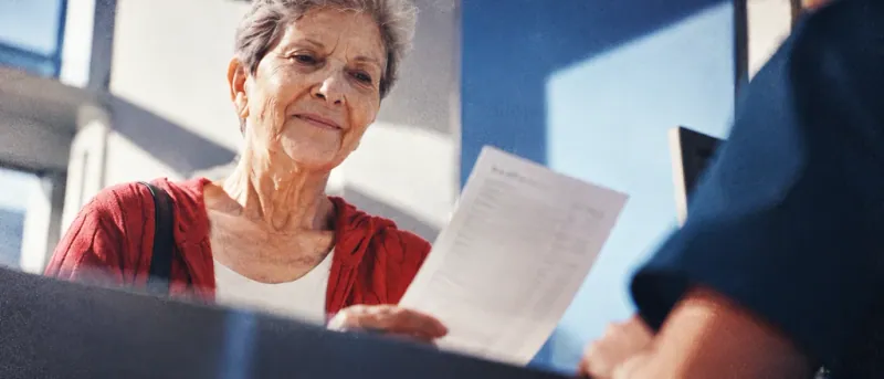 Patient reviewing a written estimate at an eye care office counter